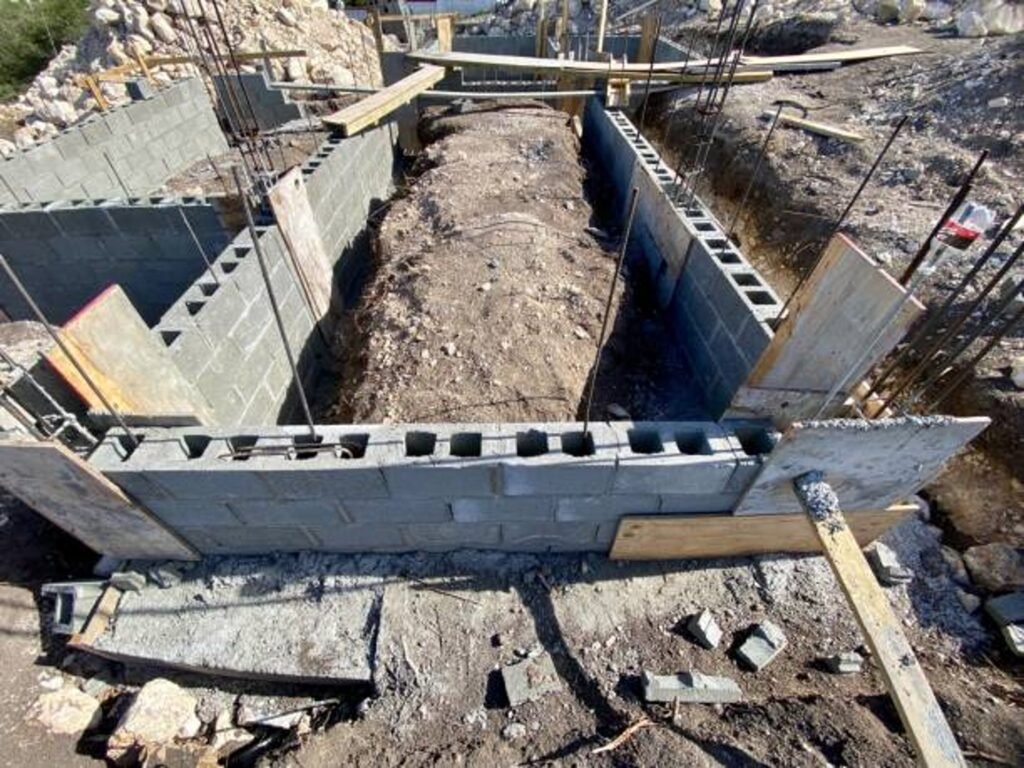 Concrete foundation installation with block walls and framing setup on the construction site in Eastlake, OH
