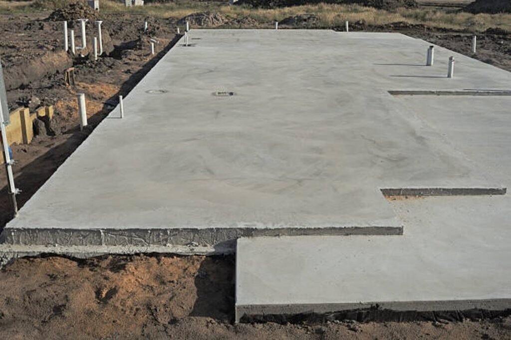 Newly poured concrete slab foundation with smooth finish and structural layout in Eastlake, OH