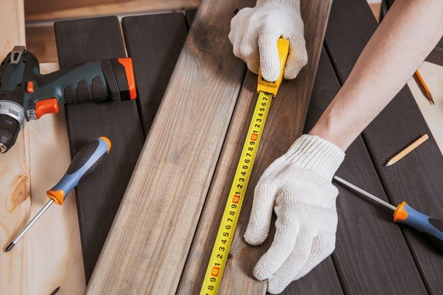 A hand working with tools on side.