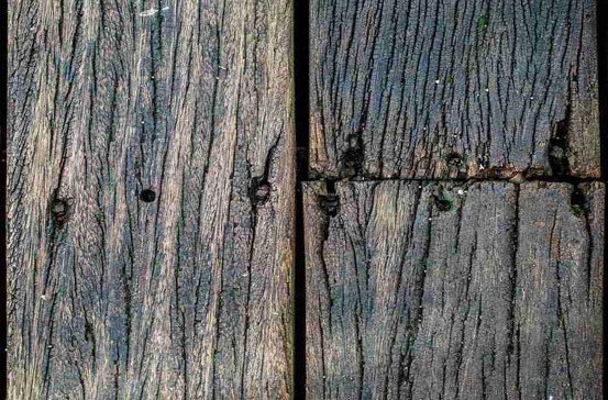 A Old wood and broken with nail on it.