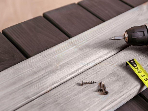 Tool with nail screw and plank with a ruler measured tool.