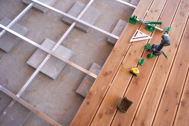 A tools with nail aside while doing custom construction deck